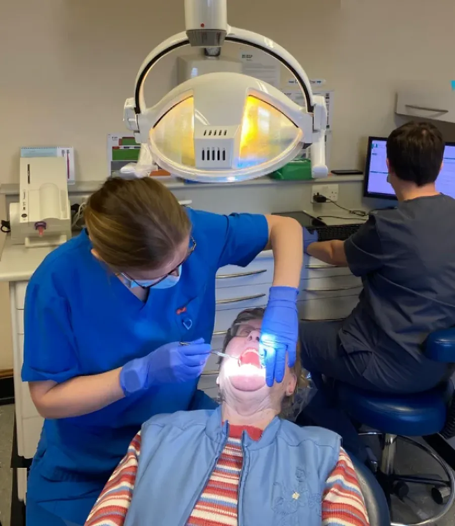 Dentist and dental nurse treating a patient inside Delta Dental Care practice